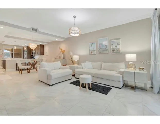 a living room with furniture and a chandelier