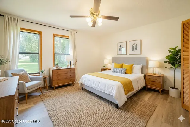 a bedroom with a bed wooden floor and window