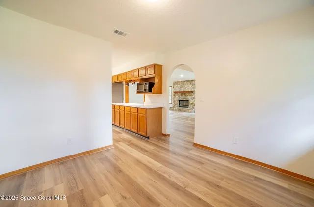a view of a room with wooden floor