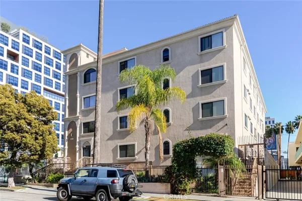 a front view of a residential apartment building with a yard