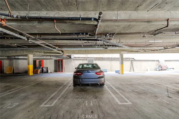 a view of parking garage with cars