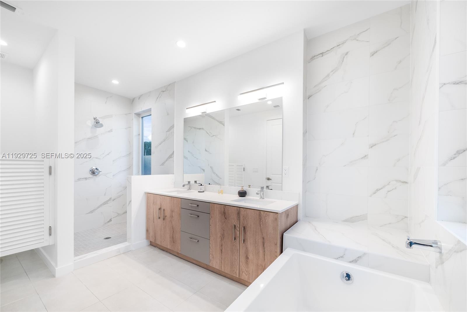 2756 Southwest 34th Court, Unit B Miami, FL 33133 - Photo 14 of 33 a bathroom with a double vanity sink mirror and bathtub