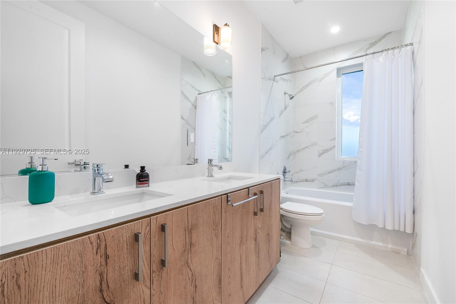 2756 Southwest 34th Court, Unit B Miami, FL 33133 - Photo 17 of 33 a bathroom with a double vanity sink toilet and shower