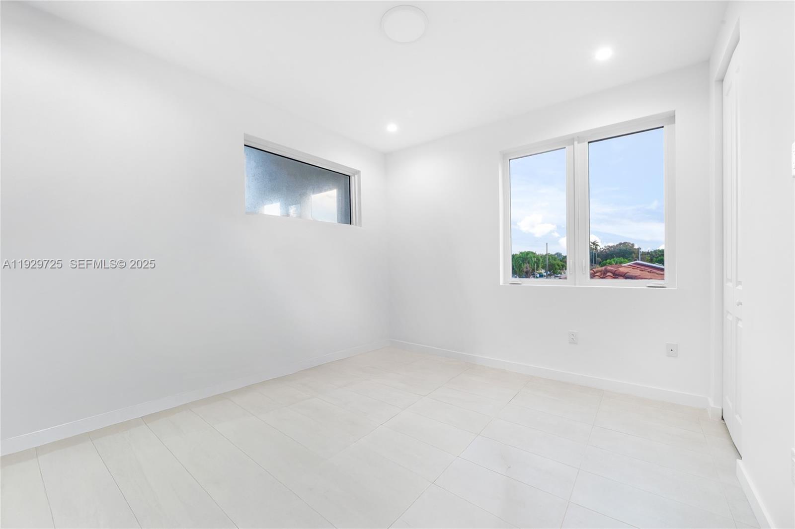 2756 Southwest 34th Court, Unit B Miami, FL 33133 - Photo 18 of 33 an empty room with windows