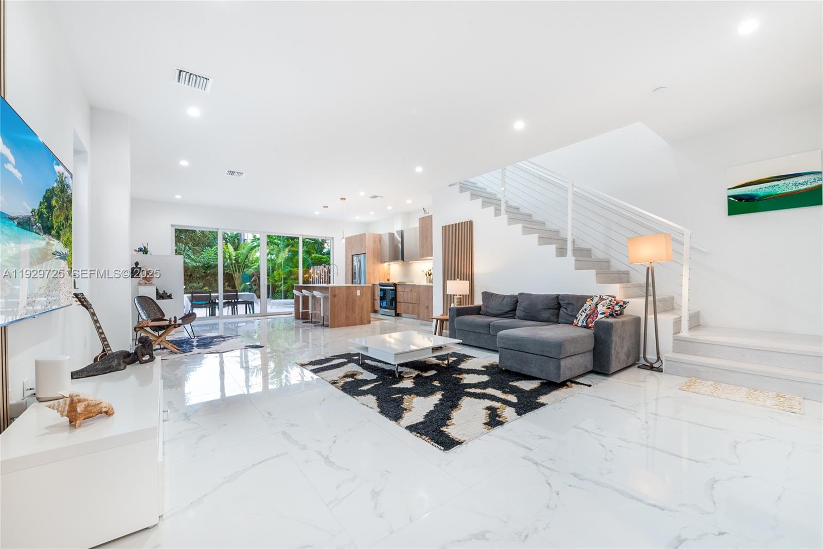 2756 Southwest 34th Court, Unit B Miami, FL 33133 - Photo 5 of 33 a living room with furniture kitchen view and a large window