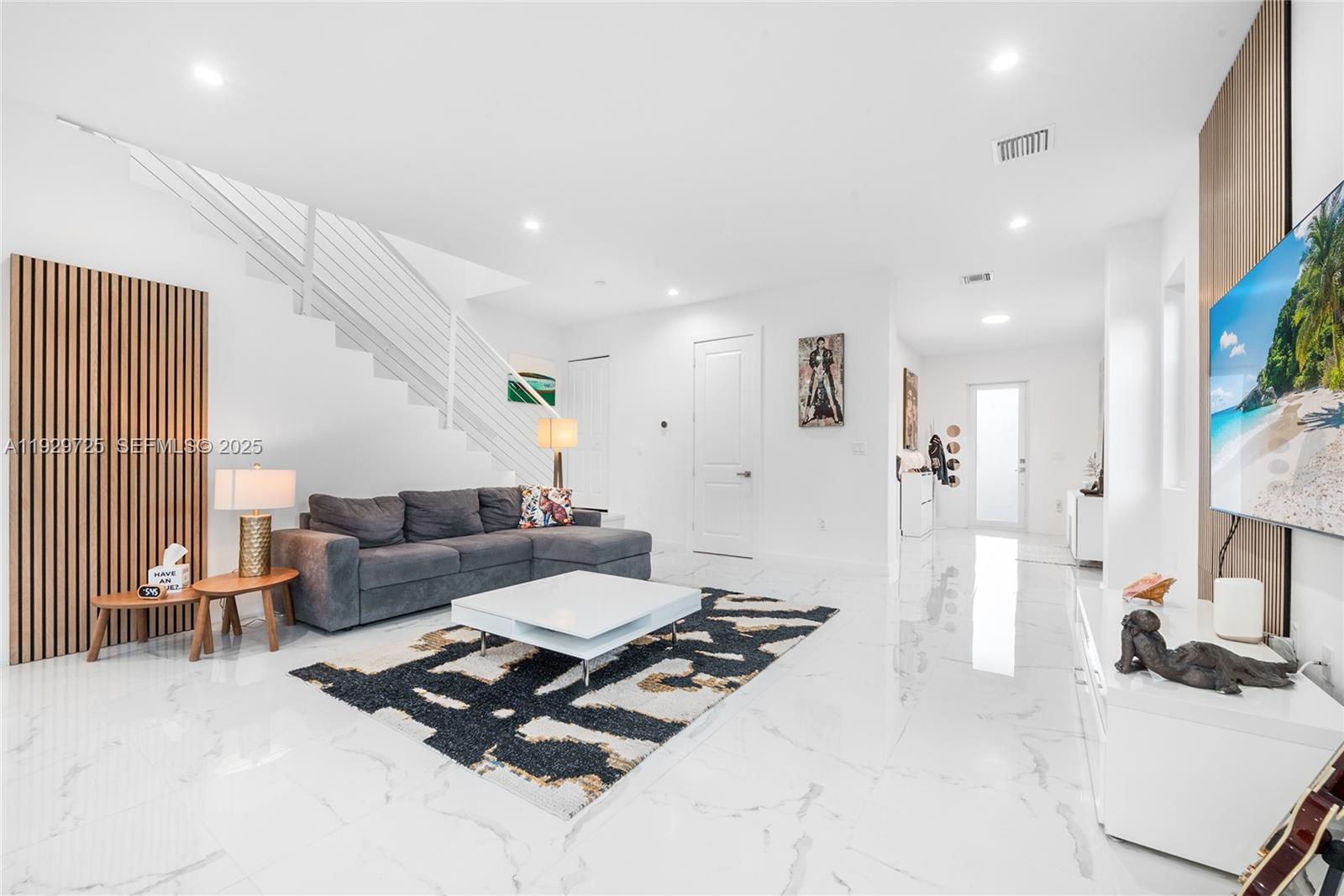 2756 Southwest 34th Court, Unit B Miami, FL 33133 - Photo 6 of 33 a living room with furniture and a flat screen tv