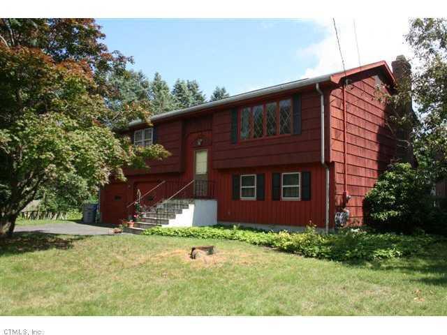 140 Ridgecrest Lane Bristol, CT 06010 - Photo 1 of 1 a brick house with a large tree in the background