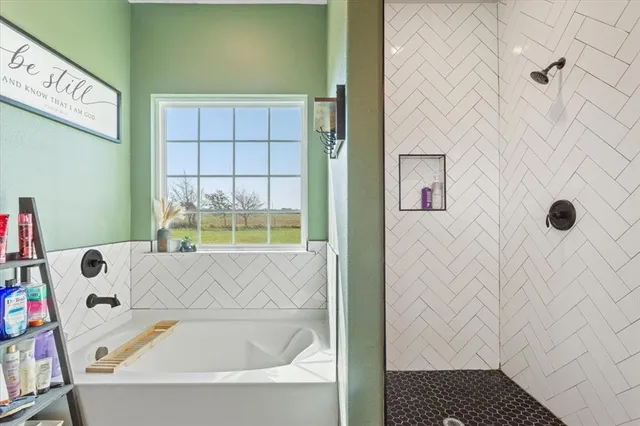 a bathroom with a bathtub and window