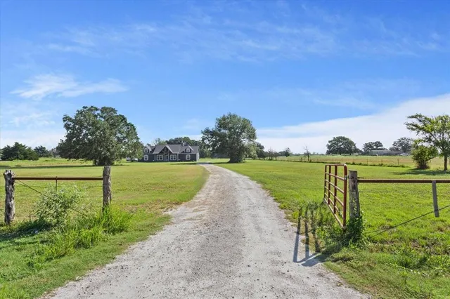 a view of a lake with a big yard and potted plants