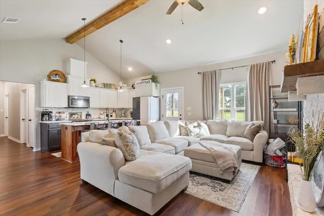 a living room with furniture fireplace and wooden floor