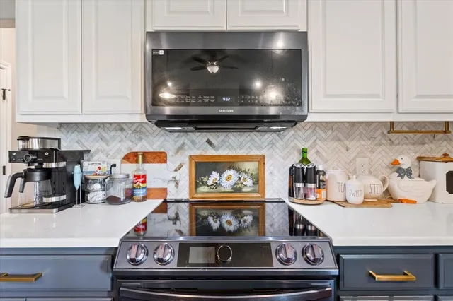 a kitchen with a stove and cabinets