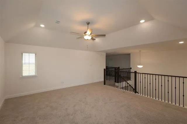 a view of a livingroom with a ceiling fan and window