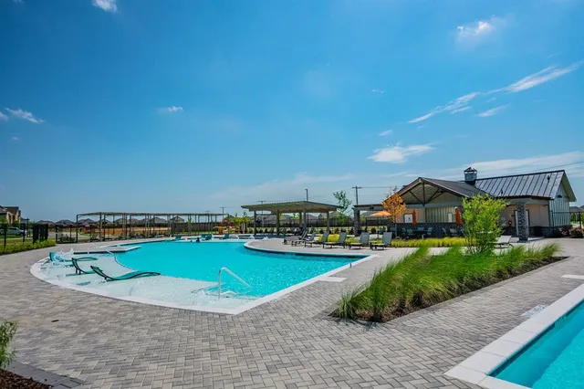 a view of a swimming pool with a yard