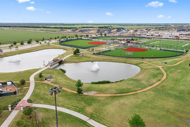 a view of a garden with a building in the background