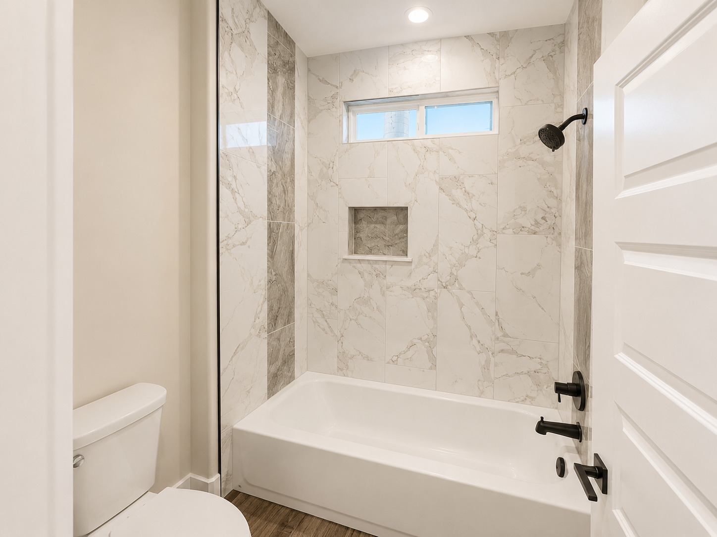 488 County Road 468 Elgin, TX 78621 - Photo 9 of 12 A well-appointed bathroom features a bathtub with a shower, complemented by stylish tile work.