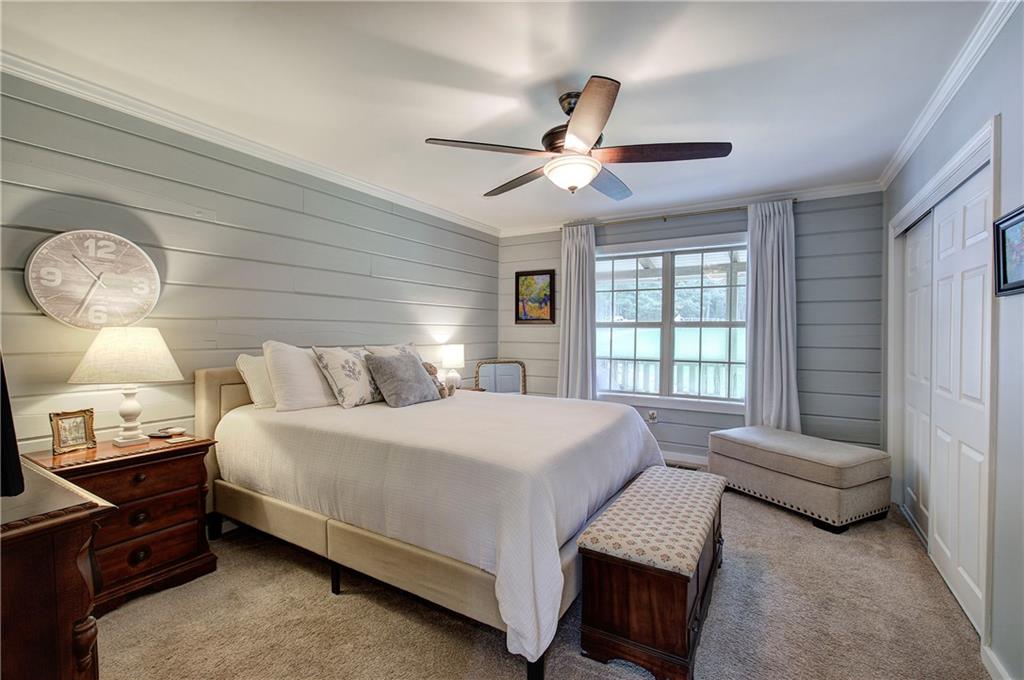 566 Old Grade Road Resaca, GA 30735 - Photo 18 of 48 a bedroom with a bed a chandelier and a window