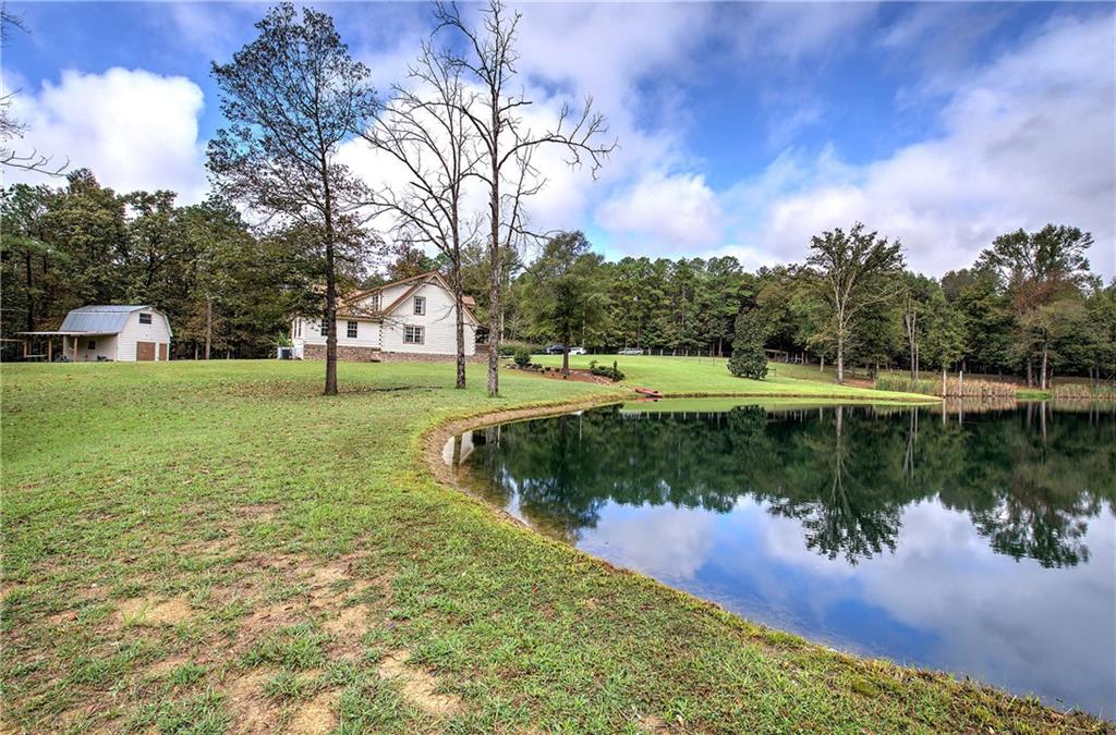 566 Old Grade Road Resaca, GA 30735 - Photo 37 of 48 a view of a lake with a yard