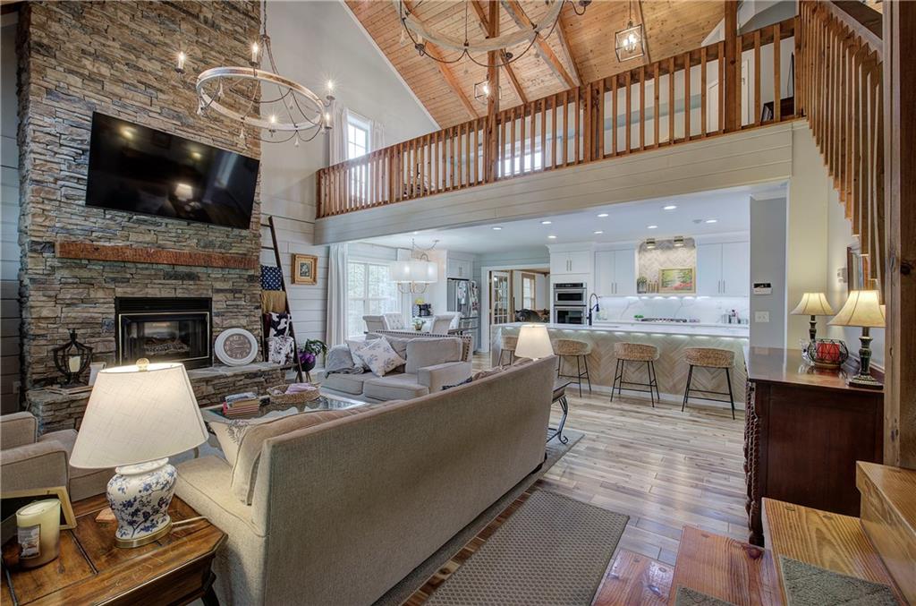 566 Old Grade Road Resaca, GA 30735 - Photo 4 of 48 a living room with stainless steel appliances furniture a fireplace a flat screen tv and kitchen view