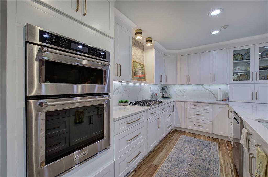 566 Old Grade Road Resaca, GA 30735 - Photo 10 of 48 a kitchen with granite countertop white cabinets stainless steel appliances and sink