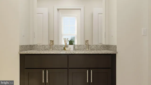 a bathroom with a granite countertop sink and a mirror