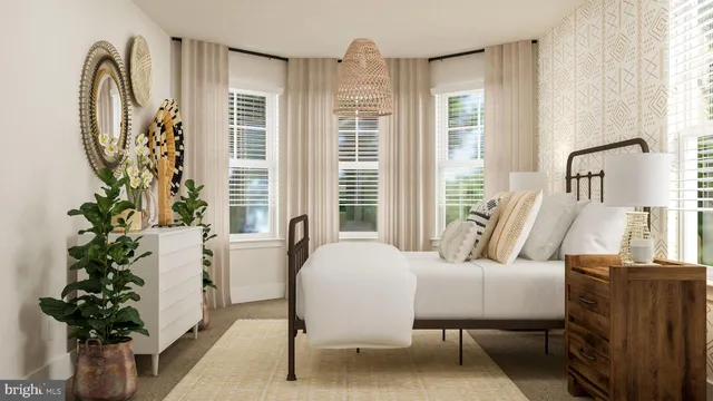 a bedroom with furniture and a potted plant