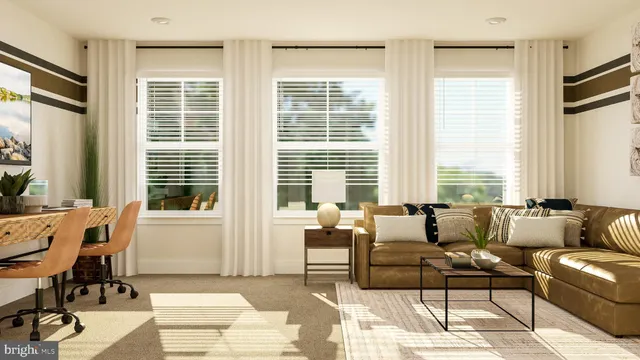 a living room with furniture and large windows