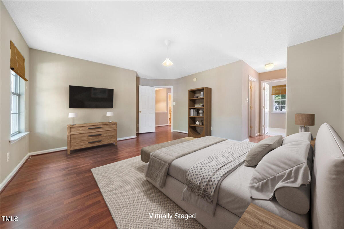 5305 Corinthian Way Raleigh, NC 27607 - Photo 12 of 21 a bedroom with a bed and a flat screen tv