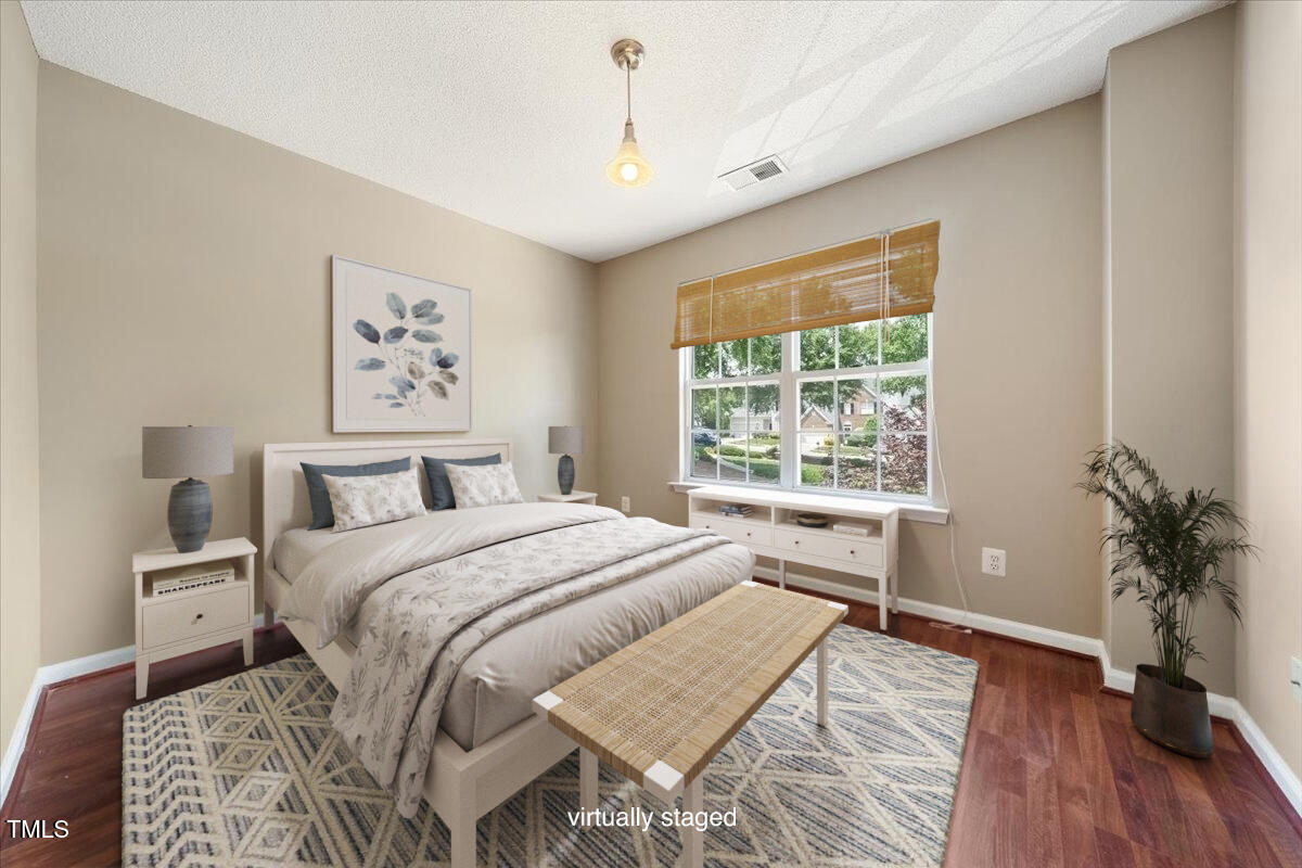 5305 Corinthian Way Raleigh, NC 27607 - Photo 16 of 21 a bedroom with a large bed and a window