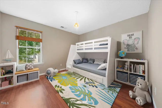 a bedroom with furniture and a wooden floor