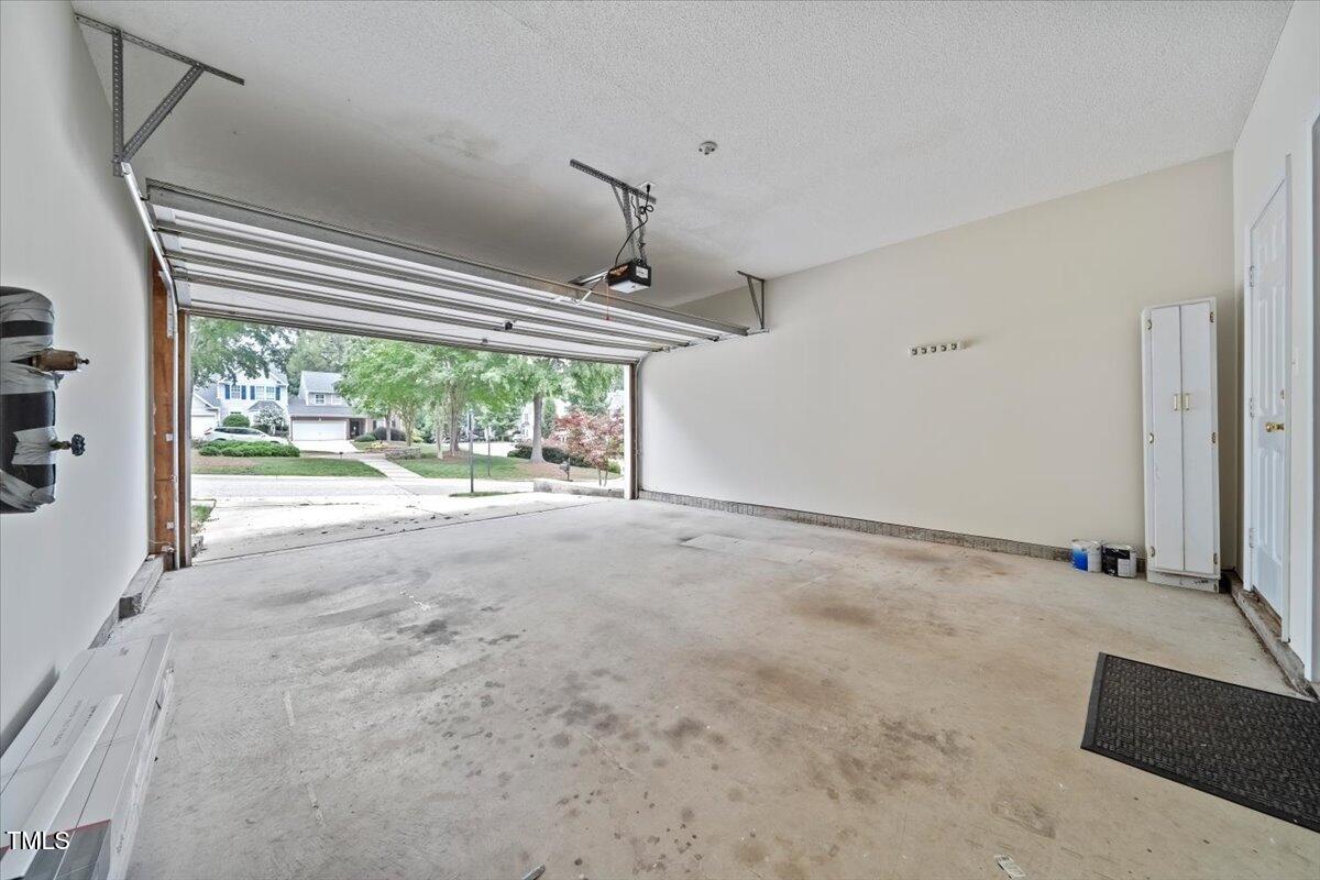 5305 Corinthian Way Raleigh, NC 27607 - Photo 21 of 21 a view of a livingroom with wooden floor a ceiling fan and windows