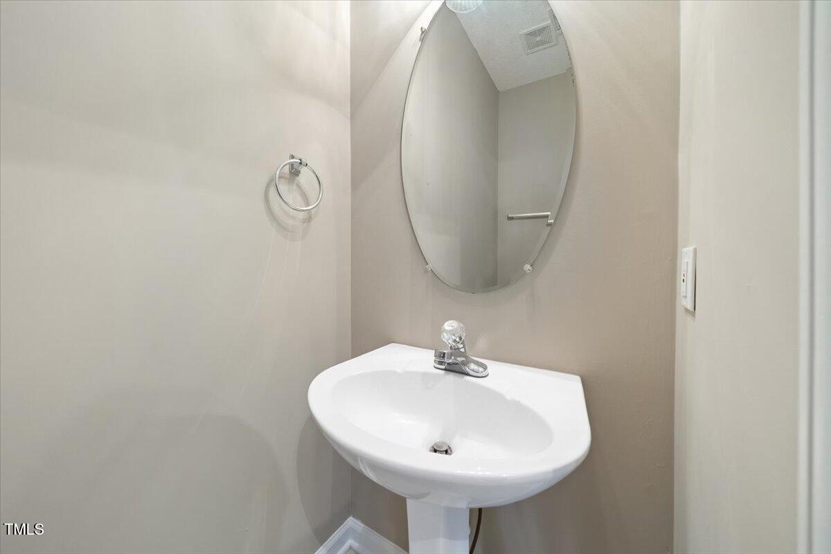 5305 Corinthian Way Raleigh, NC 27607 - Photo 10 of 21 a bathroom with a sink and a mirror
