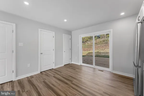 a view of wooden floor and windows in a room