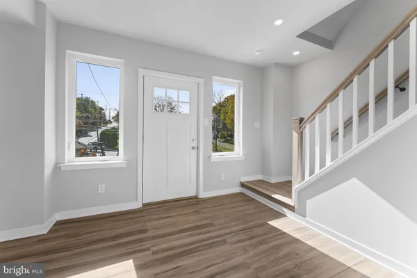 a view of an entryway with wooden floor and windows