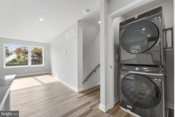 a view of a hallway with washer and dryer