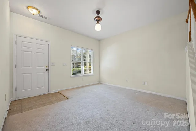an empty room with windows and closet