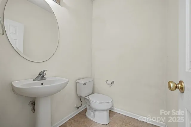 a bathroom with a sink toilet and a mirror