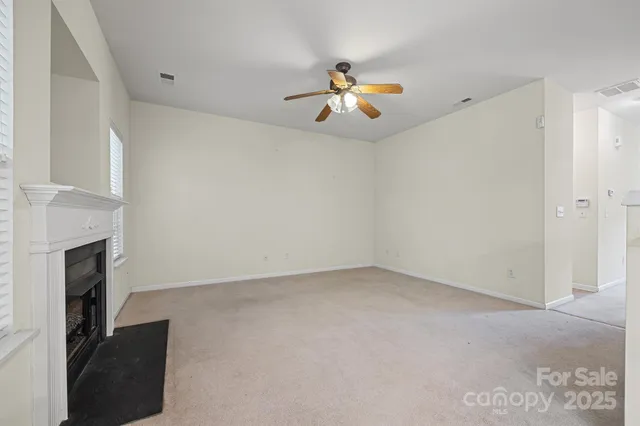 a view of an empty room with a fireplace