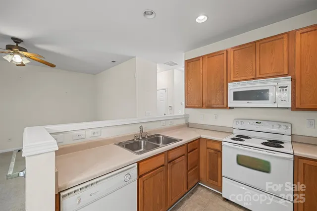 a view of a kitchen with stove top oven