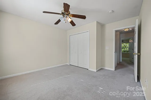 a view of empty room with ceiling fan