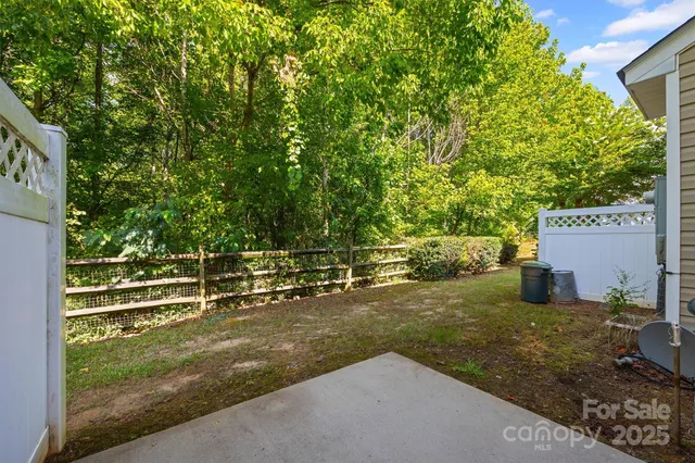 a view of a field with some trees in the background