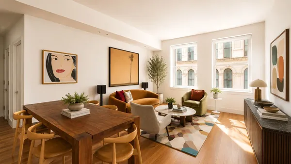 a living room with stainless steel appliances furniture a rug and a view of kitchen