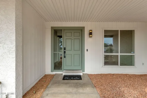 a front view of a house with a yard outdoor seating and garage