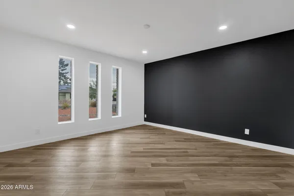 a view of an empty room and wooden floor