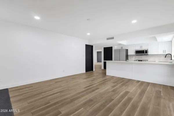 a kitchen with stainless steel appliances granite countertop a sink and wooden cabinets