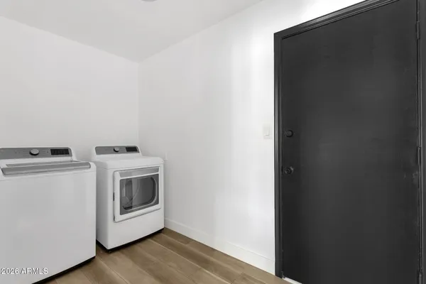 a view of kitchen with stainless steel appliances refrigerator stove and cabinets