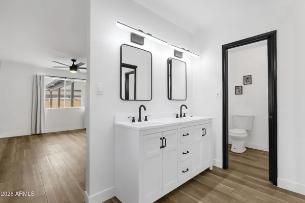 a view of a room with wooden floor and a bathroom