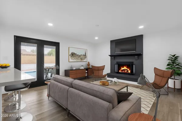a living room with furniture kitchen view and a window
