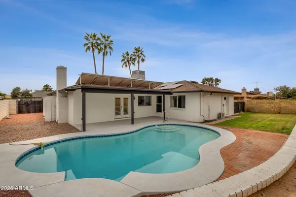 a view of a swimming pool with a yard