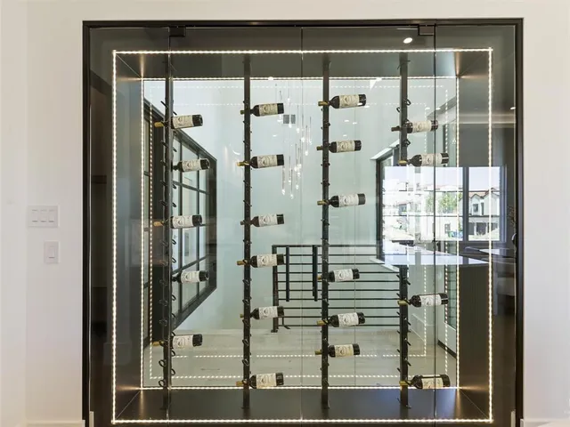 a large bathroom with a large mirror vanity and a window
