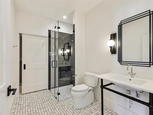 a bathroom with a shower sink and mirror